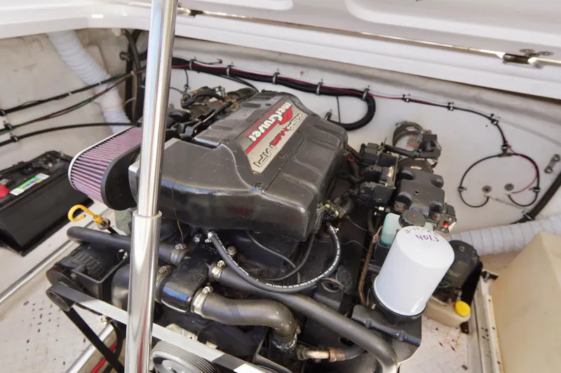 Slide: The Image of Engine compartment of a 1999 Donzi 26 ZX boat, featuring a powerful marine engine. - 23