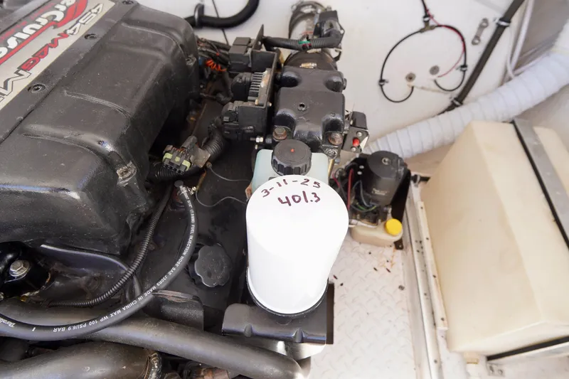 Slide: The Image of 1999 Donzi 26 ZX engine compartment with visible oil filter and components. - 24