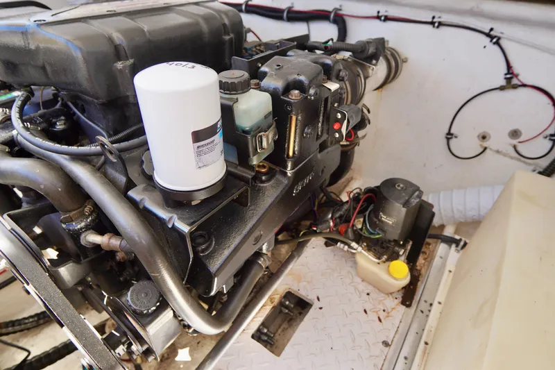 Slide: The Image of Engine compartment of a 1999 Donzi 26 ZX boat, showcasing mechanical components and wiring. - 25