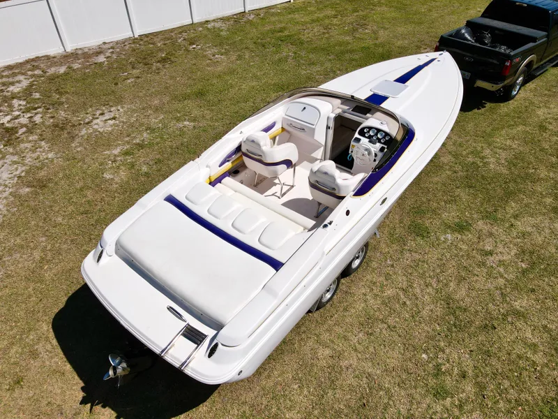 Slide: The Image of 1999 Donzi 26 ZX speedboat on grass, viewed from above, near a black truck. - 28