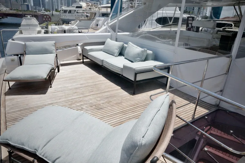 Slide: The Image of Luxurious 2016 Custom Line 97 yacht deck with elegant seating and scenic marina view. - 20