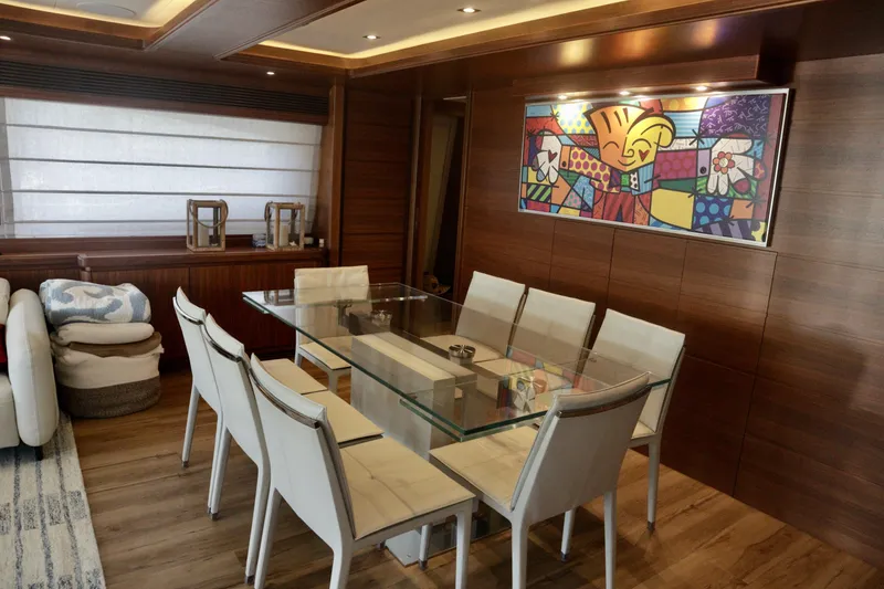 Slide: The Image of Luxurious dining area on 2016 Custom Line 97 yacht with modern decor and glass table. - 9