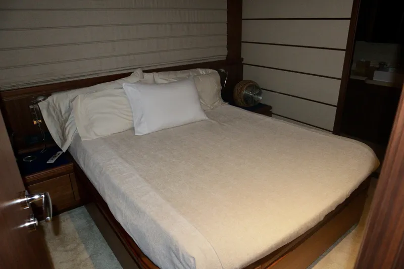 Slide: The Image of Luxurious bedroom interior on a 2016 Custom Line 97 yacht, featuring a neatly made bed. - 15