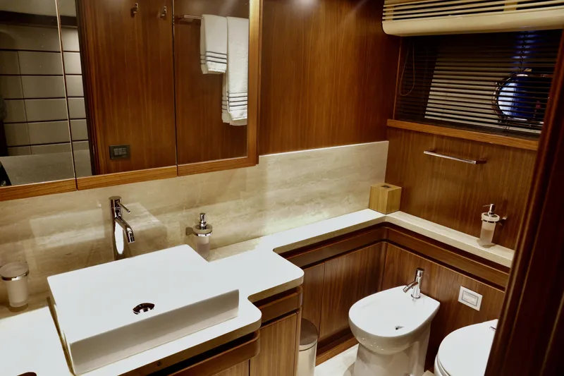 Slide: The Image of Luxurious bathroom in 2016 Custom Line 97 yacht, featuring modern fixtures and elegant wood finishes. - 25