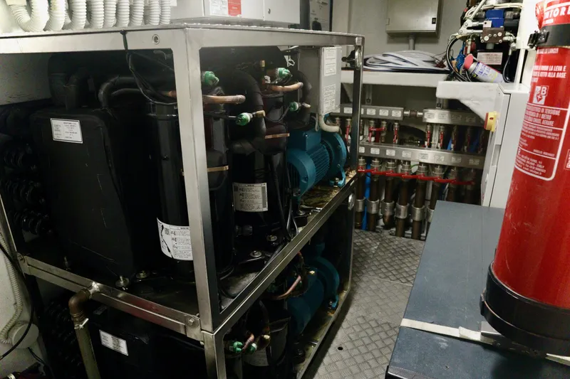 Slide: The Image of Engine room of 2016 Custom Line 97 yacht with machinery and fire extinguisher. - 29