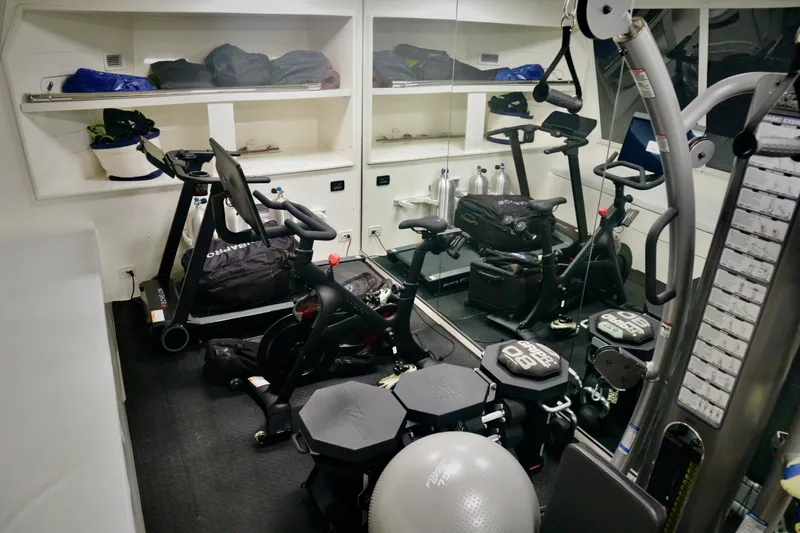 Slide: The Image of Compact gym on Custom Line 97 yacht, featuring exercise equipment and weights, 2016 model. - 26