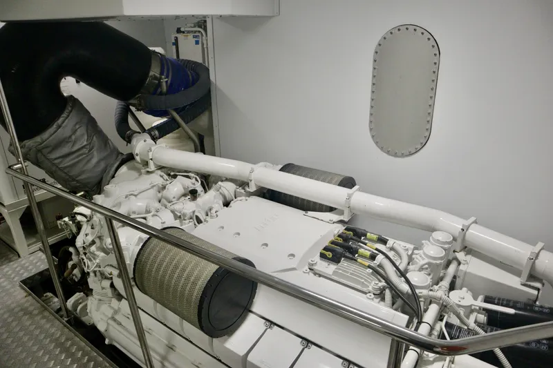 Slide: The Image of Engine room of 2016 Custom Line 97 yacht, showcasing mechanical components and piping. - 32
