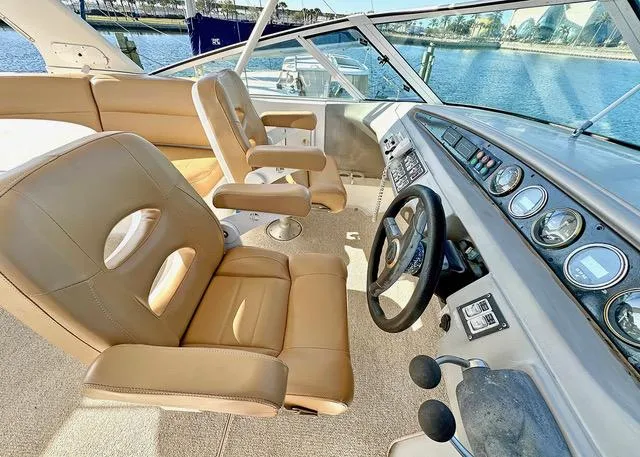 Slide: The Image of 1999 Carver 450 Voyager Pilothouse interior with tan leather seats and control panel. - 4