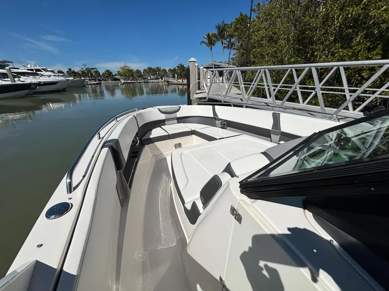 Slide: The Image of 2021 Chaparral 300 OSX boat docked, featuring spacious seating and sleek design. - 9