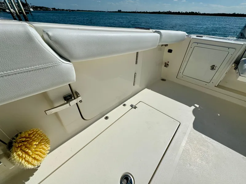 Slide: The Image of 2020 Cobia 350 Center Console boat interior with storage compartments and ocean view. - 16
