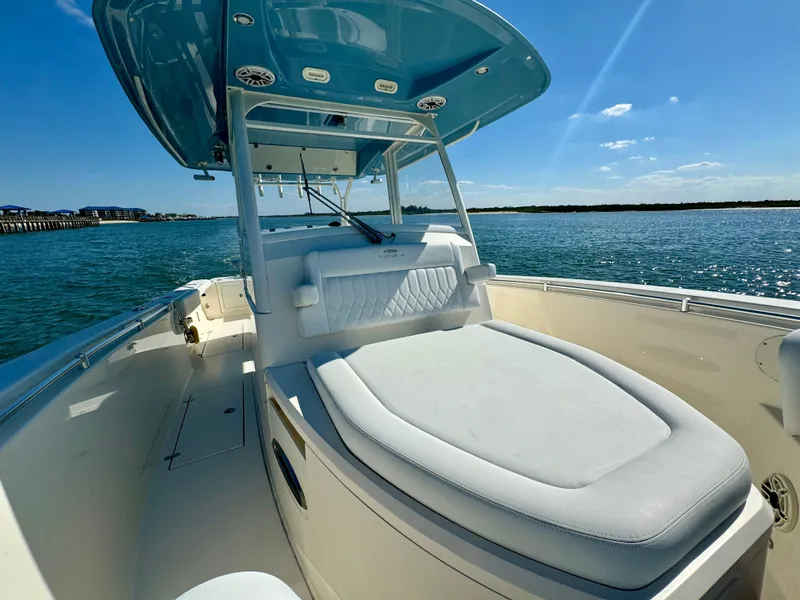 Slide: The Image of 2020 Cobia 350 Center Console boat on water, featuring spacious seating and sleek design. - 28