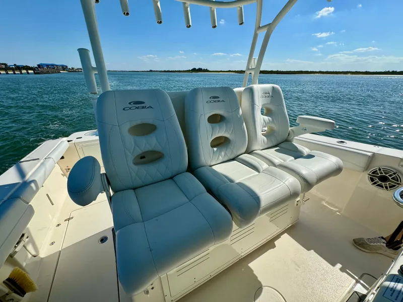 Slide: The Image of 2020 Cobia 350 Center Console boat with luxurious white seating, ocean backdrop. - 29