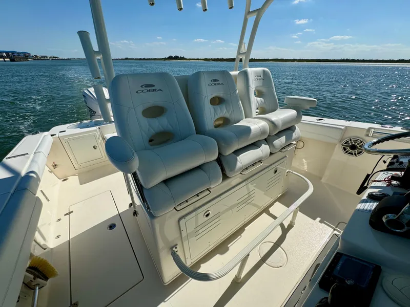 Slide: The Image of 2020 Cobia 350 Center Console boat interior with plush seating on a sunny day. - 30
