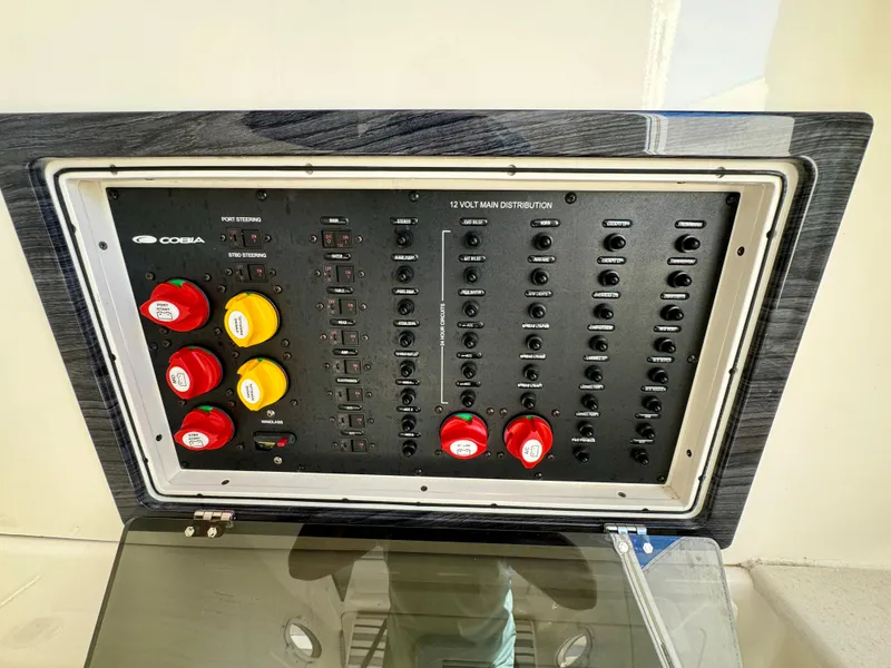 Slide: The Image of Control panel of a 2020 Cobia 350 Center Console boat with switches and dials. - 45