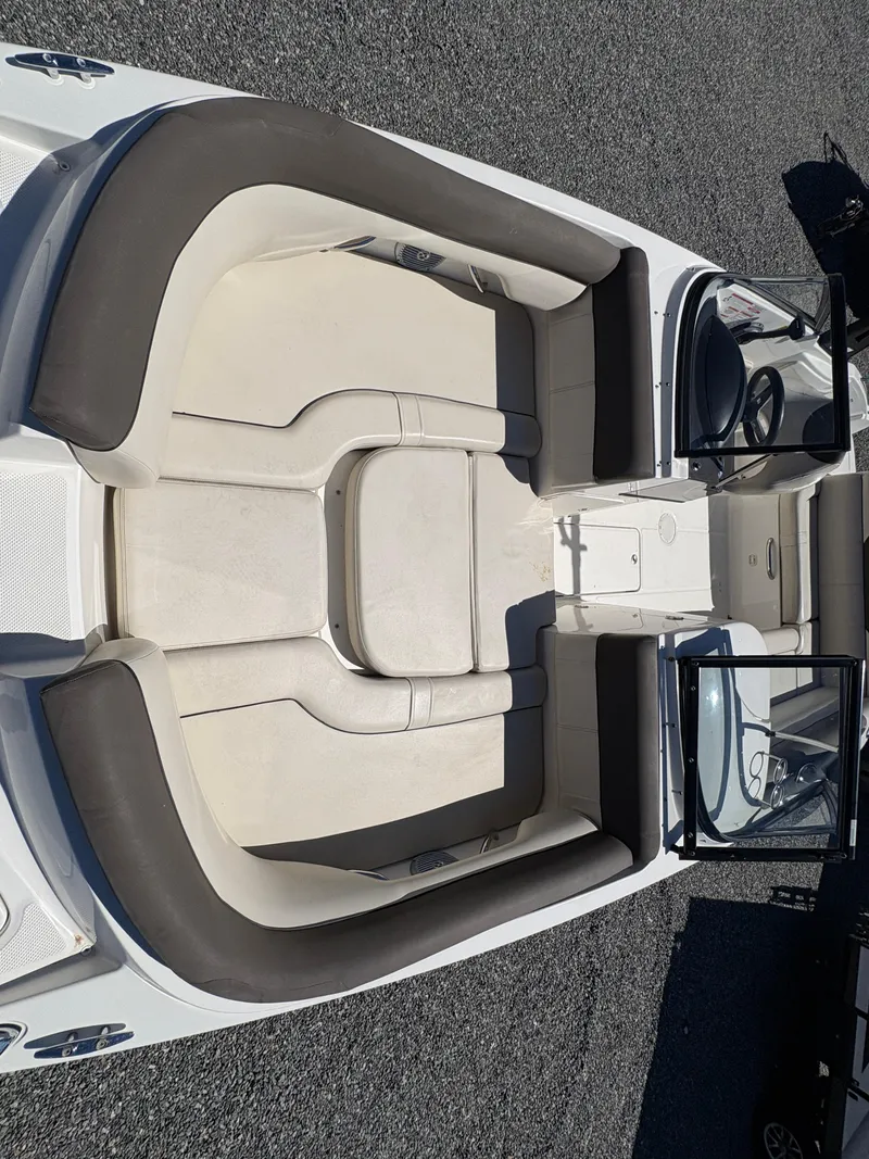 Slide: The Image of 2019 Bayliner 210 Deck Boat interior with spacious seating and steering console. - 19
