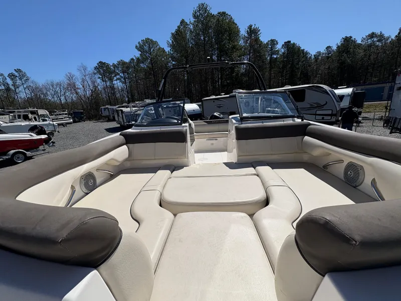 Slide: The Image of 2019 Bayliner 210 Deck Boat with spacious seating, parked outdoors. - 21