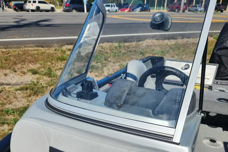 Slide: The Image of 2019 Tracker Pro V 175 Guide boat with windshield, parked near a road. - 11