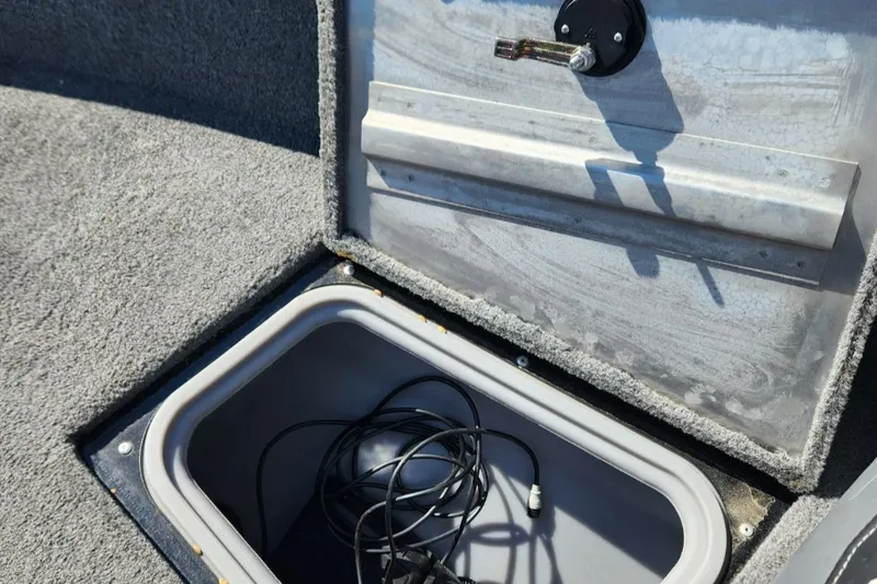 Slide: The Image of Open storage compartment in 2019 Tracker Pro V 175 Guide boat with cables inside. - 15