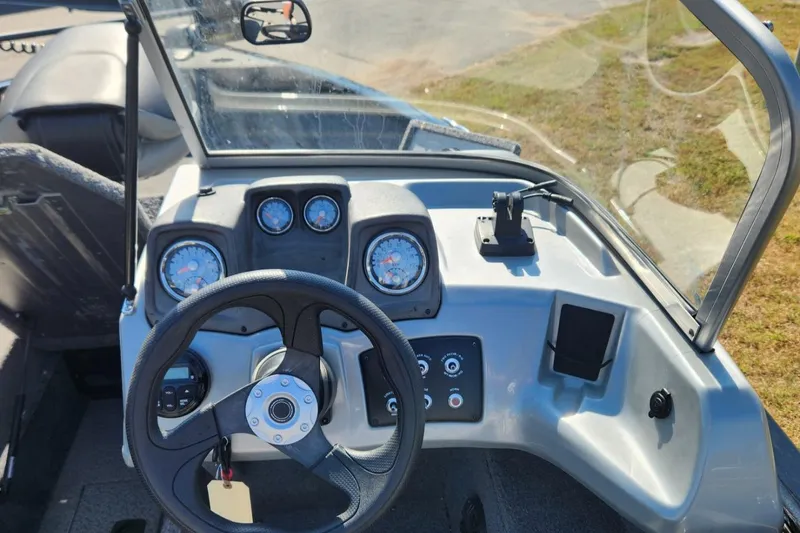 Slide: The Image of 2019 Tracker Pro V 175 Guide boat dashboard with steering wheel and gauges. - 18