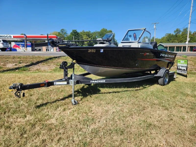 Slide: The Image of 2019 Tracker Pro V 175 Guide boat on trailer, parked on grass near a gas station. - 3