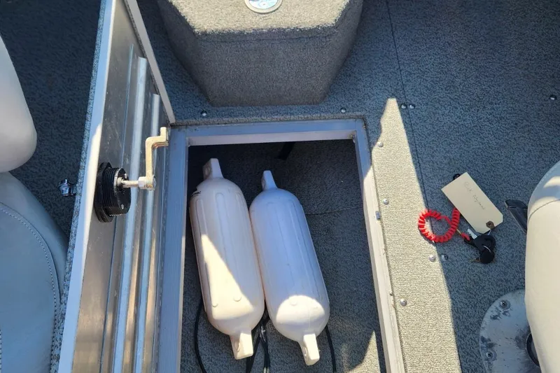 Slide: The Image of 2019 Tracker Pro V 175 Guide boat storage compartment with fenders and safety equipment. - 9