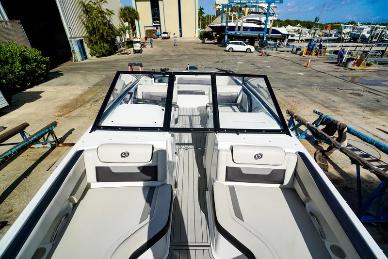 Slide: The Image of 2021 Hurricane SunDeck 235 OB boat at marina, showcasing spacious seating and sleek design. - 12