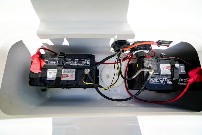 Slide: The Image of Battery compartment of 2021 Hurricane SunDeck 235 OB boat, showing wiring and connections. - 16