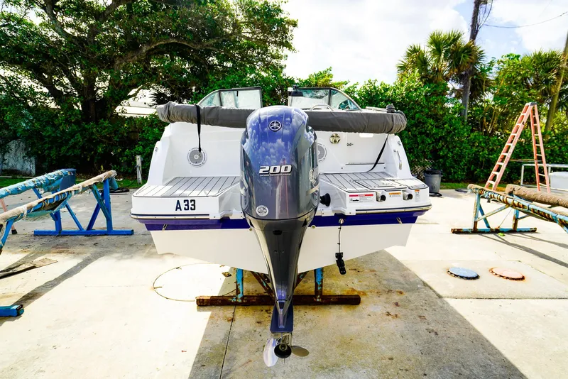 Slide: The Image of 2021 Hurricane SunDeck 235 OB boat with Yamaha 200 outboard motor on a sunny day. - 18
