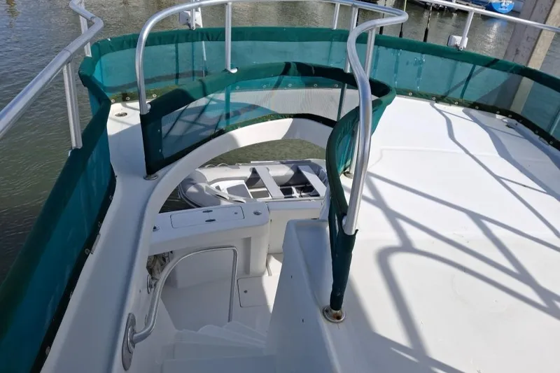 Slide: The Image of 1997 Mainship 350 yacht deck with green railings and white stairs. - 11