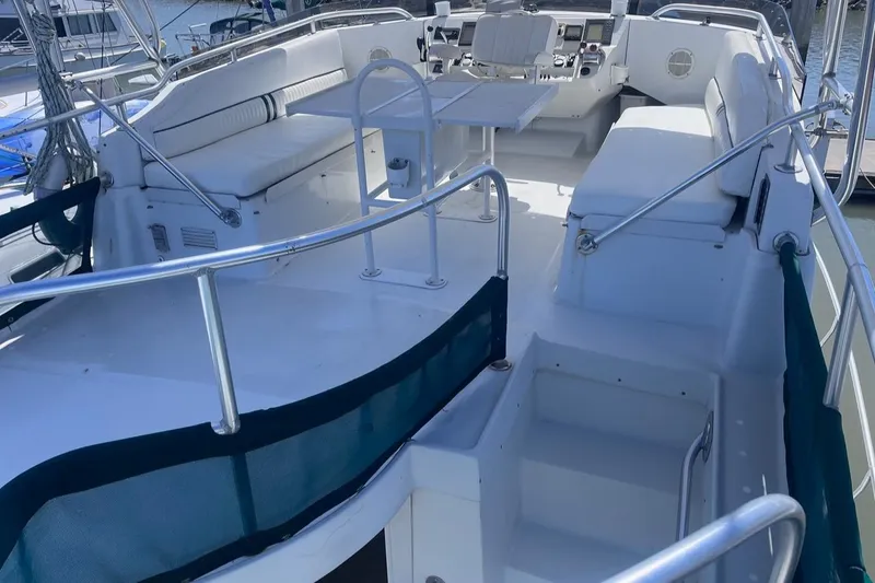 Slide: The Image of 1997 Mainship 350 yacht deck with seating and helm, featuring sleek design and modern amenities. - 12
