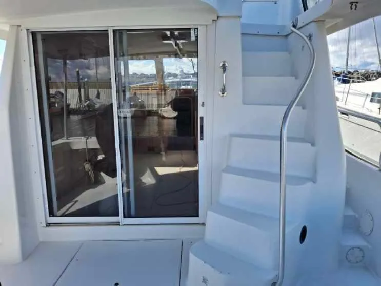 Slide: The Image of 1997 Mainship 350 yacht with sliding glass door and spiral staircase. - 13
