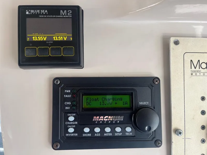 Slide: The Image of Control panel on a 1997 Mainship 350, featuring Blue Sea and Magnum energy monitors. - 17