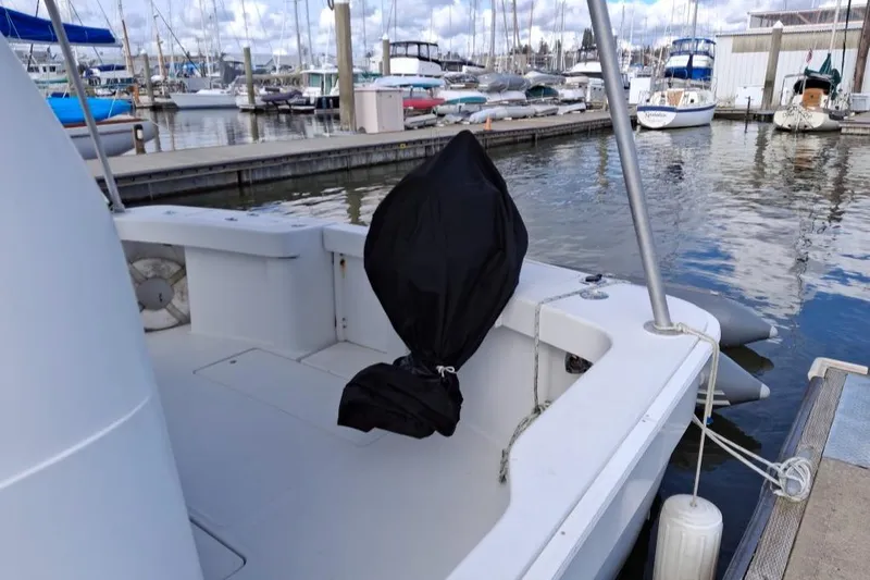 Slide: The Image of 1997 Mainship 350 boat docked at marina, covered equipment on deck. - 26