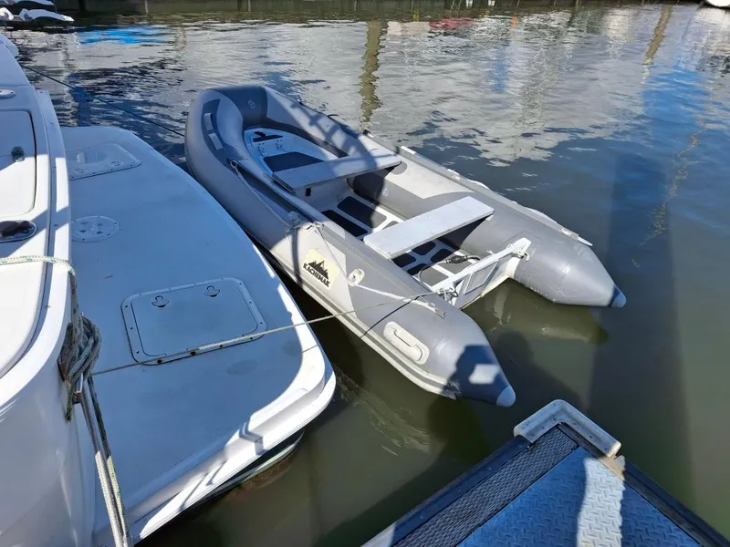 Slide: The Image of Inflatable dinghy moored beside a 1997 Mainship 350 yacht in a marina. - 27