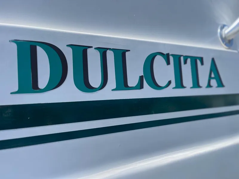 Slide: The Image of Close-up of "DULCITA" name on 1997 Mainship 350 boat hull. - 31