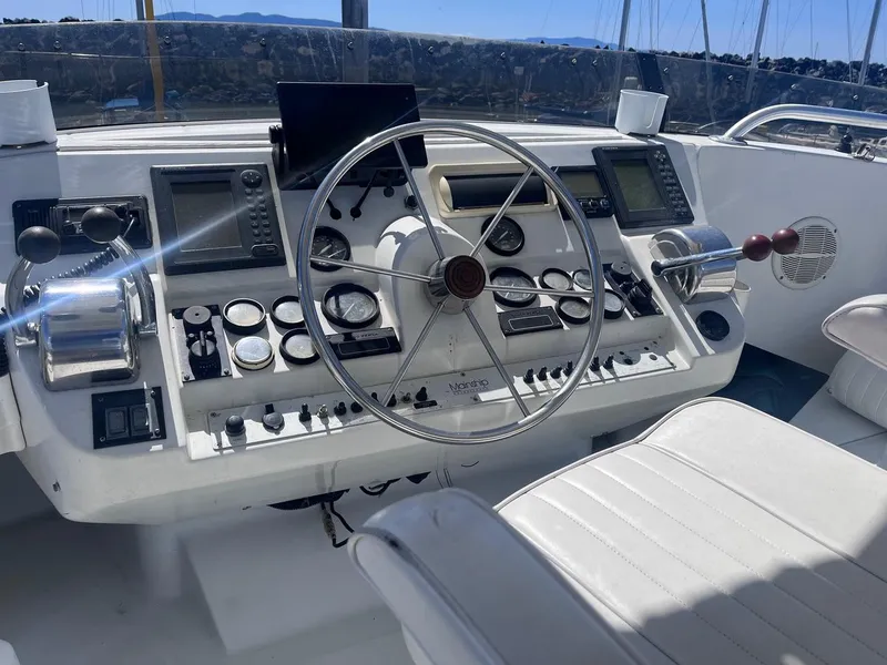 Slide: The Image of 1997 Mainship 350 helm with steering wheel, gauges, and navigation equipment. - 7