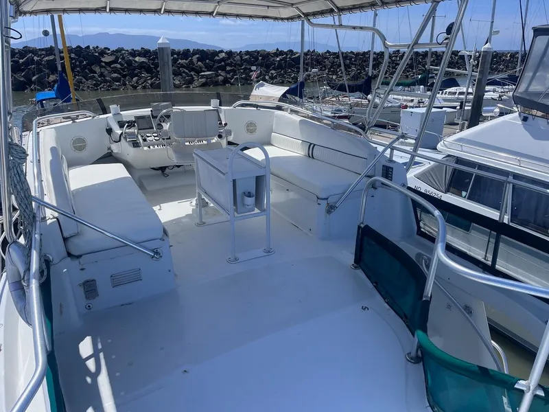 Slide: The Image of 1997 Mainship 350 boat deck with seating, helm, and marina view. - 8
