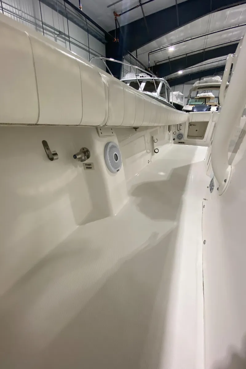 Slide: The Image of 2015 Regulator 34 Center Console boat interior in a showroom. - 10