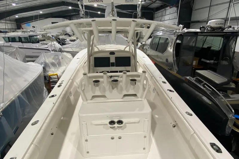 Slide: The Image of 2015 Regulator 34 Center Console boat in a storage facility, featuring a sleek helm design. - 13