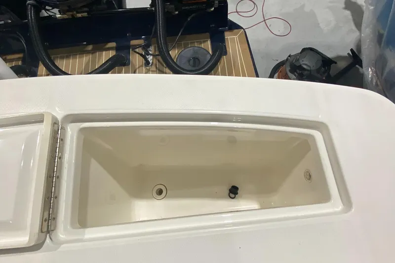 Slide: The Image of 2015 Regulator 34 Center Console boat storage compartment, open and empty. - 15