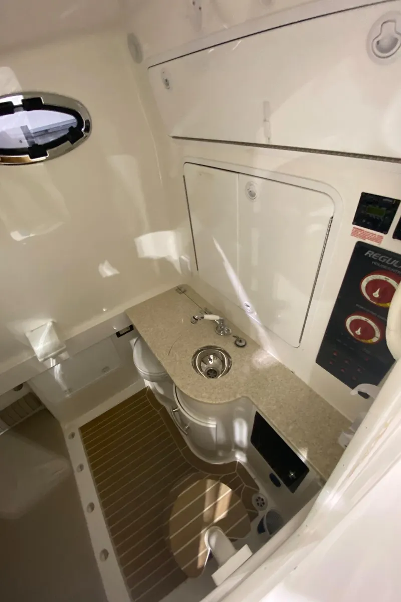 Slide: The Image of 2015 Regulator 34 Center Console interior with sink and control panel. - 2