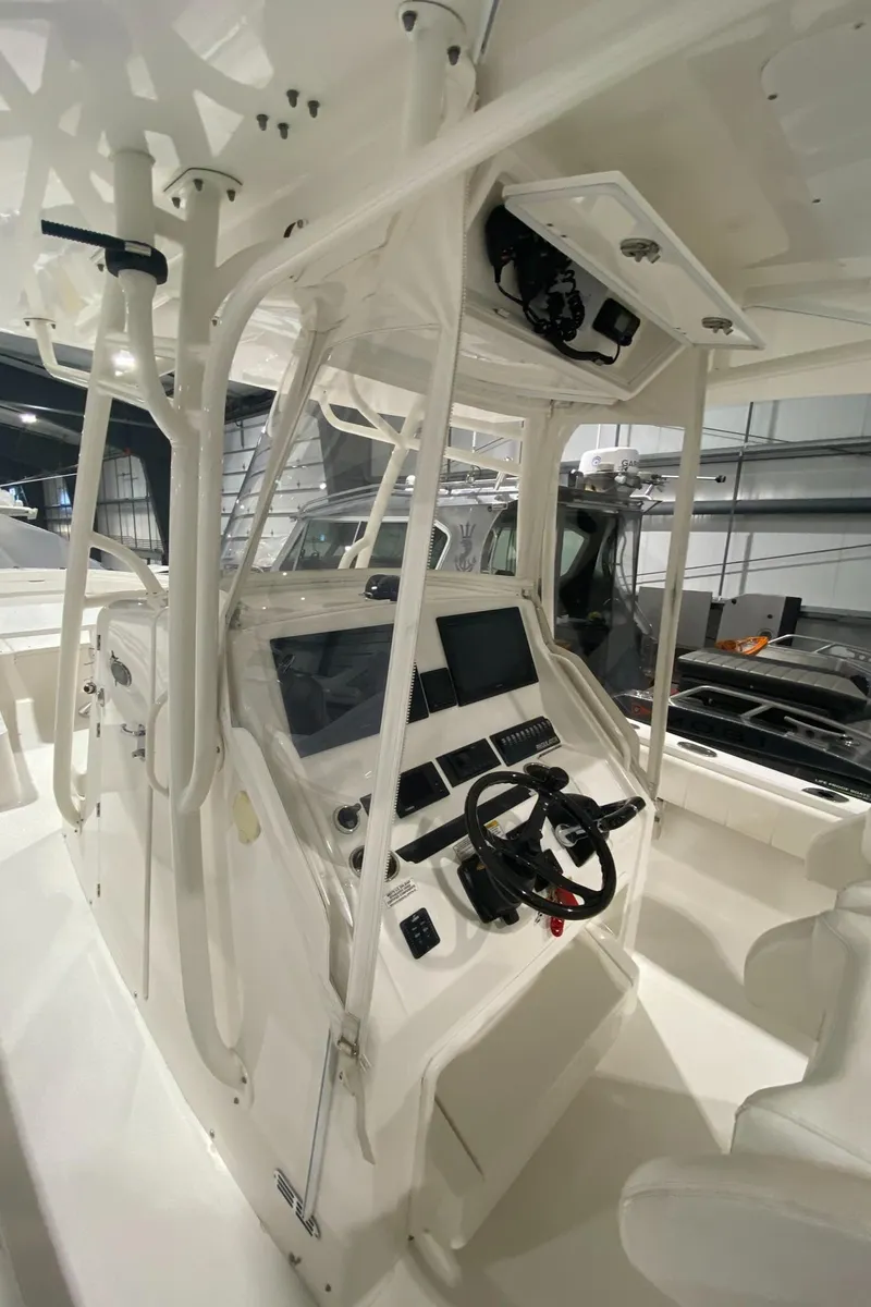 Slide: The Image of 2015 Regulator 34 Center Console boat interior with steering wheel and control panel. - 20