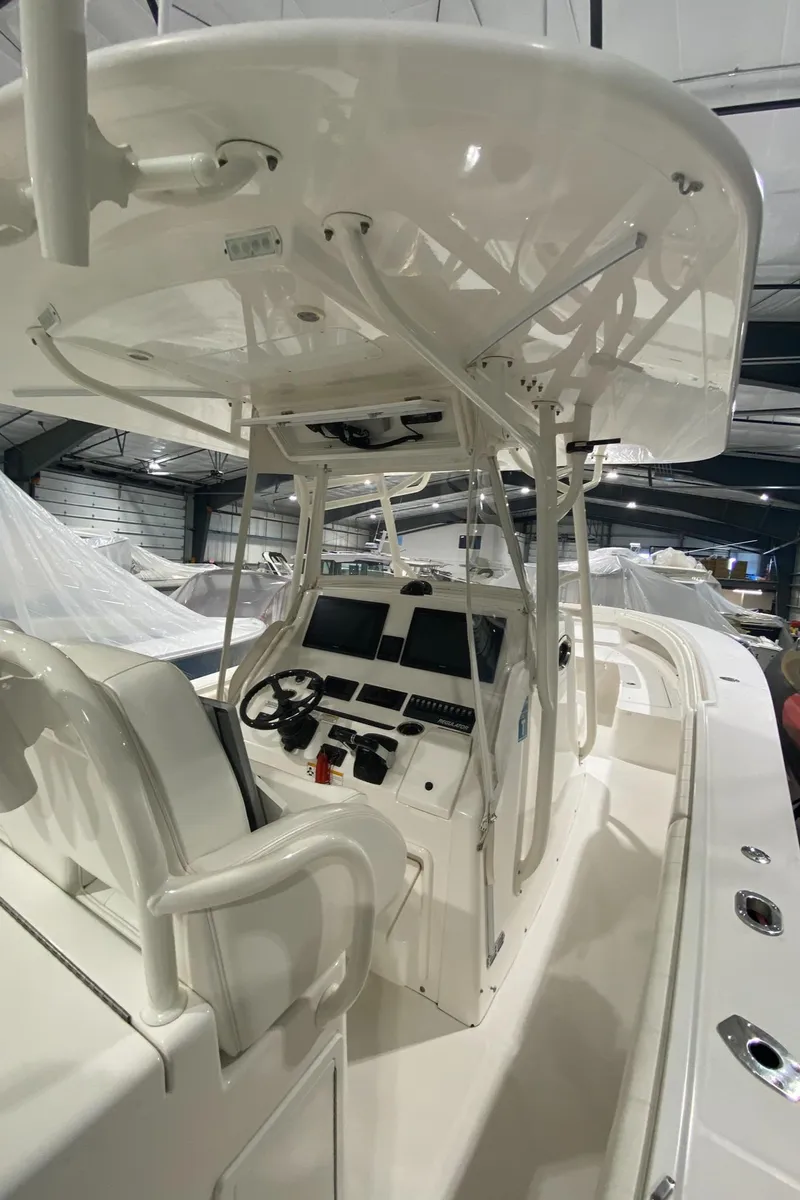 Slide: The Image of 2015 Regulator 34 Center Console boat interior with helm and seating. - 21