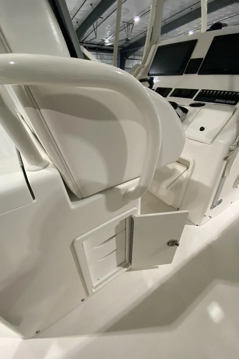 Slide: The Image of 2015 Regulator 34 Center Console interior with open storage compartment and control panel. - 22