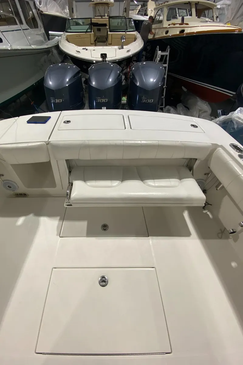 Slide: The Image of 2015 Regulator 34 Center Console boat with triple engines in storage. - 23