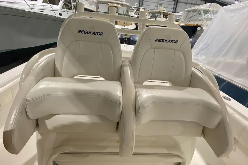 Slide: The Image of 2015 Regulator 34 Center Console boat seats in a showroom setting. - 24