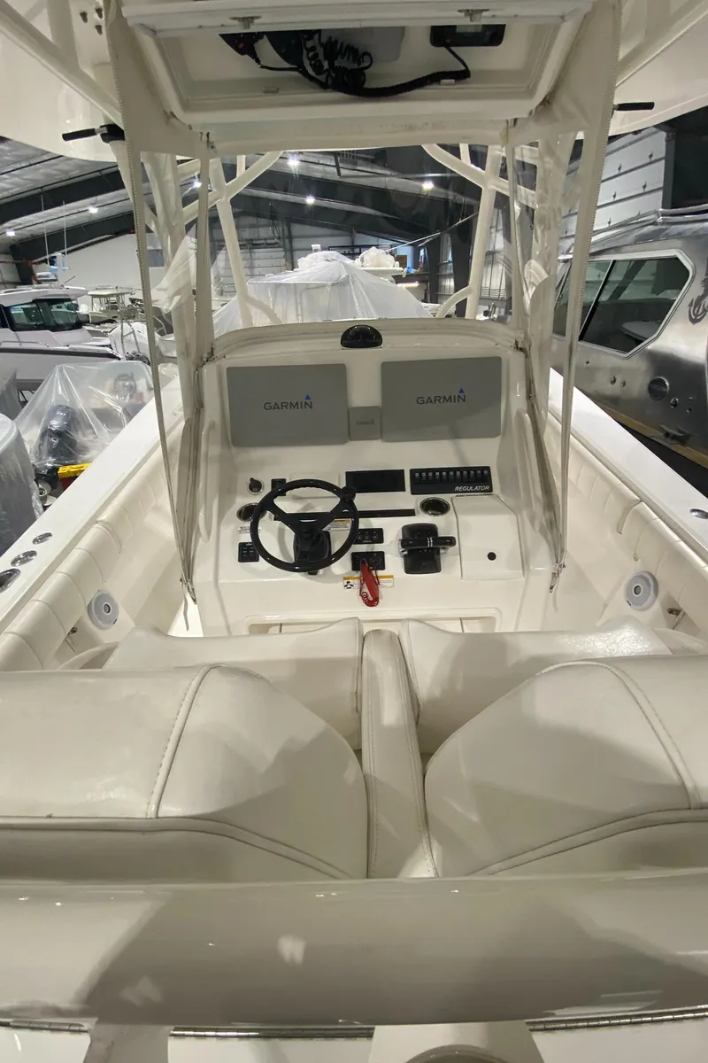 Slide: The Image of 2015 Regulator 34 Center Console boat interior with helm and seating. - 25