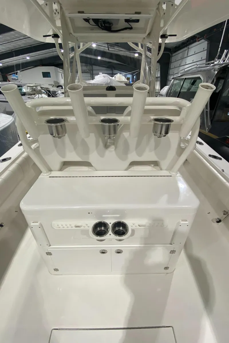 Slide: The Image of 2015 Regulator 34 Center Console boat interior with rod holders and storage compartments. - 26