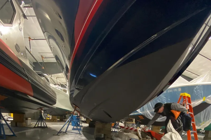 Slide: The Image of 2015 Regulator 34 Center Console boat in a workshop, undergoing maintenance. - 33