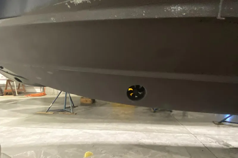 Slide: The Image of 2015 Regulator 34 Center Console hull in a workshop setting. - 34